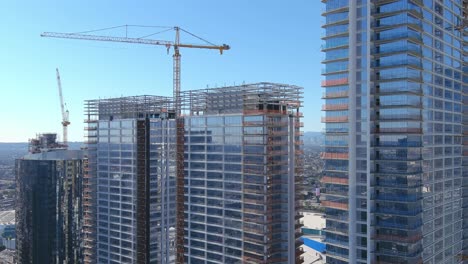 High-rise-lofts-under-construction-in-Downtown-Los-Angeles-|-Rising-aerial-shot-|-Sunny-Day