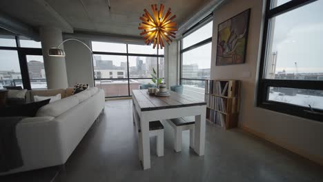 Modern-Kitchen-Table-Located-in-a-Downtown-Minneapolis-Condo-Building-with-Large-Windows-and-Cars-Going-By-Outside