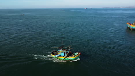 Aerial-tracking-shot-of-fisherman-boat-returning-home-after-fishing-day