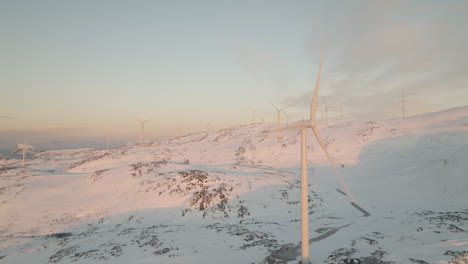 Wind-turbines-producing-green-energy-in-white-winter-landscape