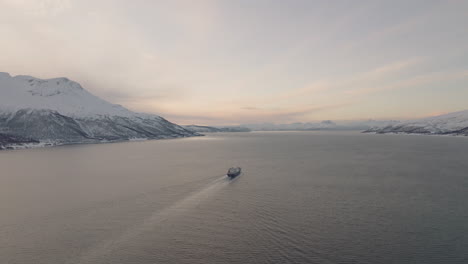 Boat-With-Cargo-Sailing-In-The-Calm-Waters-Of-Fjord-At-Winter-From-Above