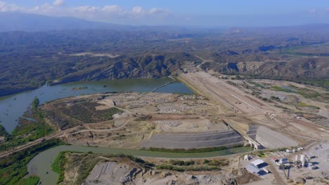 Aerial-drone-view-overlooking-a-hydroelectric-plant-construction-site,-in-Dominican-republic