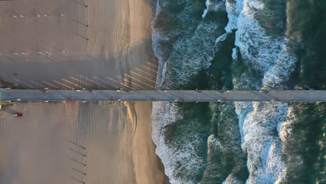 Top-down-View-Of-Pier-And-Beach-With-Sea-Waves