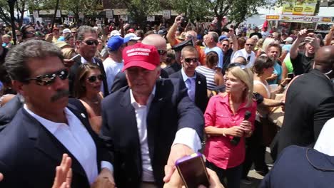 Presidential-Candidate-Donald-Trump-Walks-Through-A-Crowd-Of-Supporters-At-A-County-Fair-Political-Rally-During-The-Republican-Iowa-Caucus-Primary-Campaign