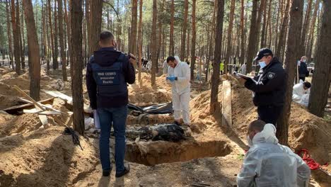 War-Crimes-Investigators-Exhume-Bodies-From-Mass-Graves-In-Izium,-Ukraine-Following-The-Regions-Liberation-From-Russian-Occupation