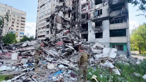 Ukrainian-Soldiers-Inspect-A-Destroyed-Apartment-Complex-On-The-Front-Line-In-Eastern-Ukraine-During-The-War