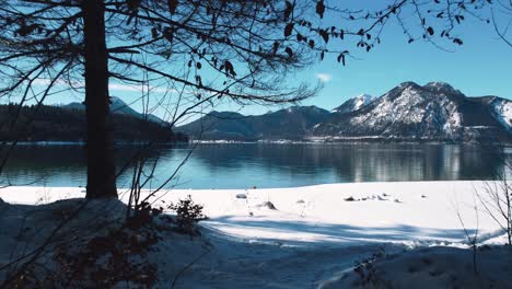 Snow-beach-at-Lake-Walchensee-in-Bavaria,-south-Germany-in-the-alps-mountains-close-to-Austria