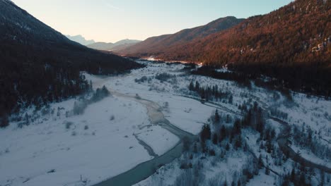 Scenic-Bavarian-Austrian-alps-mountain-river-valley-with-fresh-water-at-Sylvensteinspeicher-by-sunset-sunshine,-winter-snow-riverbed,-trees-and-forest-and-mountains