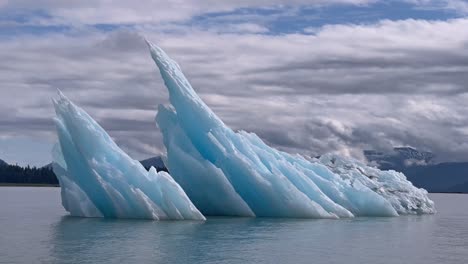 A-Sharp-Iceberg-Juts-Out-Of-The-Water-In-Alaska'S-Laconte-Bay