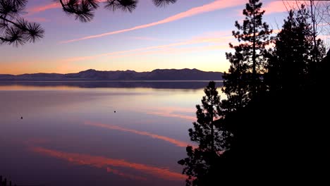 Amazing-Orange-Jet-Contrails-Are-Reflected-On-The-Placid-Lake-Surface-Of-Lake-Tahoe,-California,-Nevada