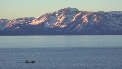 A-Couple-Rowing-A-Canoe-On-The-Calm-Waters-Lake-Tahoe,-Nevada,-California-In-Winter