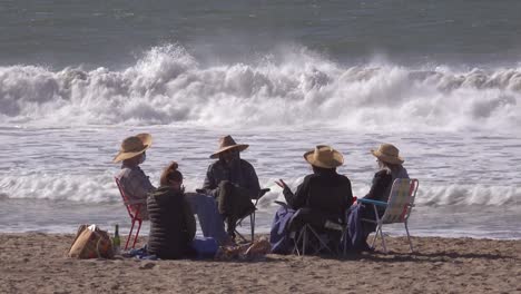 A-Masked-Family-Gathers-At-The-Beach-In-California-During-The-Covid-19-Coronavirus-Epidemic-Cfisis-Wearing-Masks