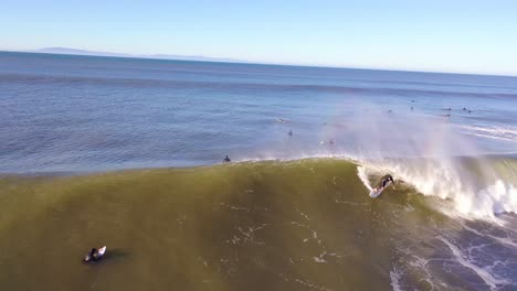 Aerial-Of-Surfer-Surfing-Riding-Large-Ocean-Waves-With-Surf-Breaking-Off-The-Coast-Of-Ventura,-California