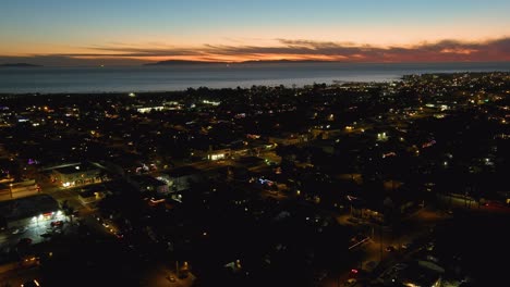 Good-Aerial-Over-Generic-California-Suburbia-Coastal-City-Town-Of-Ventura-At-Dusk-Or-Night-With-Suburban-Buildings-And-Traffic