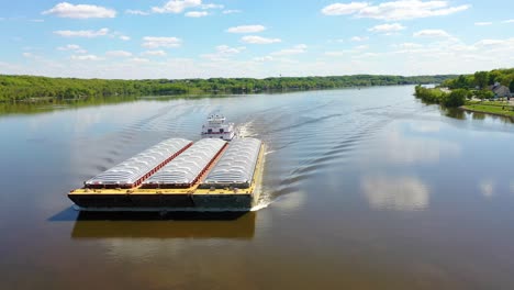 Very-Good-Drone-Aerial-Along-The-Mississippi-River-At-Le-Claire,-Iowa-Of-Old-Riverboat-And-Barge-Heading-Upstream