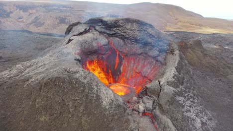 Drone-Aerial-High-View-Of-Active-Volcano-Crater-Fagradalsfjall-Volcano-With-Lava-Boulders-Falling-In-In-Iceland