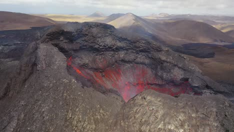 Amazing-Drone-Aerial-High-View-Of-Active-Volcano-Crater-Fagradalsfjall-Volcano-With-Lava-Boulders-Falling-In-In-Iceland
