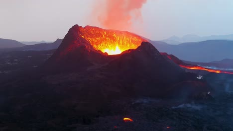 Spektakulärer-Lava-Feuerfall-Aus-Der-Luft,-Der-Den-Inneren-Kegel-Des-Fagradalsfjall-Vulkans-Hinuntersprengt.-Vulkanausbruch-Bei-Nacht