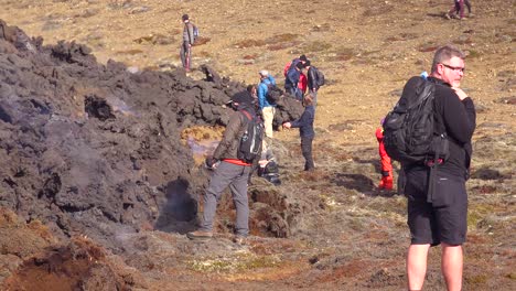 Tourists-Walk-Up-To-The-Edge-Of-Volcanic-Lava-Flow-During-The-Fagradalsfjall-Volcano-Volcanic-Explosive-Eruption-In-Iceland