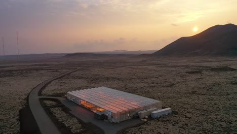 Very-Good-Aerial-Establishing-Shot-Of-A-Remote-Geothermal-Experimental-Greenhouse-In-A-Lonely-Section-Of-Iceland-At-Sunset