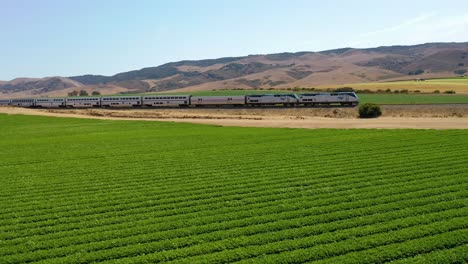 Aerial-Of-Amtrak-Passenger-Train-Traveling-Through-Generic-California-Farm-Country-Near-Martinez,-California