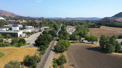 Aerial-Following-Shot-Of-Amtrak-Passenger-Train-Arriving-In-San-Luis-Obispo,-California