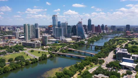 Beautiful-High-Helicopter-Aerial-Over-The-Colorado-River-In-Downtown-Austin,-Texas-With-Skyline-Background