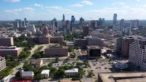 Beautiful-Aerial-Establishing-Shot-Over-Downtown-Austin,-Texas-Reveals-The-State-Capitol-Building-In-The-Distance