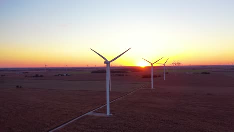 Excellent-Aerial-Of-Windmills-Generating-Clean-Electricity-On-The-Flat-Farmlands-Of-Indiana,-Illinois,-At-Dawn-Or-Sunset