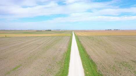 Aerial-Over-A-Long-Straight-Road-Through-Iowa,-Illinois-Or-Indiana-Flat-Farmland