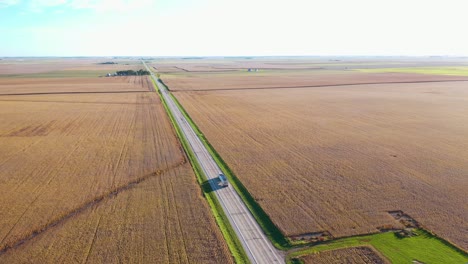 Excellent-Aerial-Of-A-Lone-Truck-Traveling-On-A-Lonely-Highway-In-The-Farmlands-Of-The-Midwest,-Illinois,-Indiana,-Or-Iowa