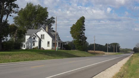 A-Pretty-White-Country-House-From-The-19Th-Century-Along-A-Pretty-Rural-Road-In-The-Midwest,-America