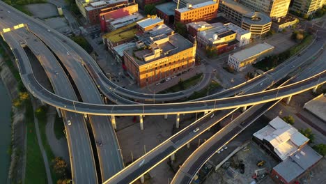 Aerial-Over-Freeway-Interchange-In-Louisville,-Kentucky-Tilts-Up-To-Reveal-Downtown-Skyline