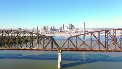 Aerial-Over-Ohio-River-Bridges-With-The-Louisville,-Kentucky-Downtown-Skyline-Distant