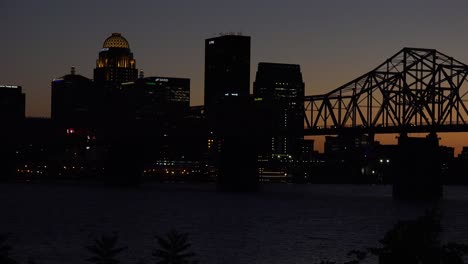 Good-Night-Establishing-Shot-Of-Louisville,-Kentucky-Downtown-Skyline,-With-George-Rogers-Clark-Memorial-Bridge-In-Foreground