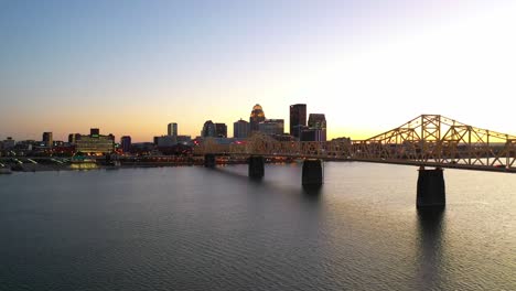 Good-Dusk-Aerial-Establishing-Shot-Of-Louisville,-Kentucky-Downtown-Skyline,-With-George-Rogers-Clark-Memorial-Bridge-In-Foreground