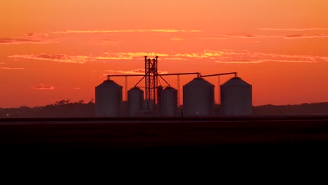 Grain-Silos-On-A-Large-Commercial-Farm-At-Dusk-In-The-Midwest