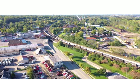 Aerial-Over-A-Long-Freight-Train-Of-Oil-Tanker-Cars-Moving-Fast-Through-The-Rural-Midwest