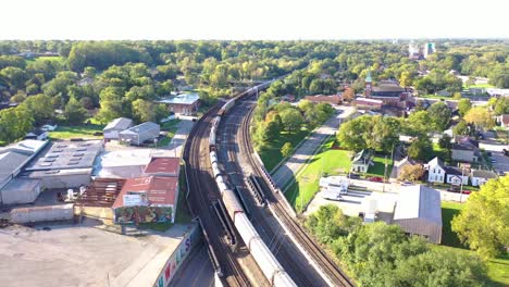 Aerial-Over-A-Long-Freight-Train-Of-Oil-Tanker-Cars-Moving-Fast-Through-The-Rural-Midwest