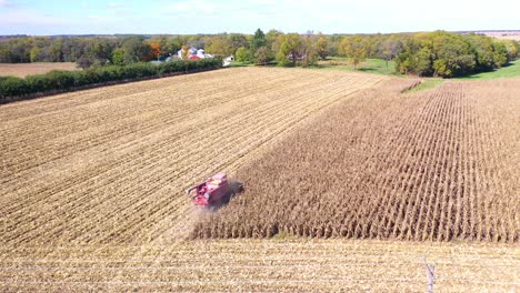 Aerial-Of-A-Harvester-Combine-At-Work-In-Cornfields-On-A-Rural-Midwest-Farm