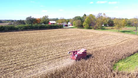 Aerial-Of-A-Harvester-Combine-At-Work-In-Cornfields-On-A-Rural-Midwest-Farm