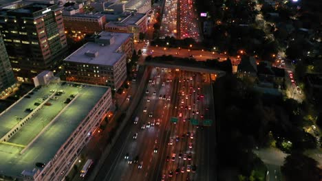 Tilting-Aerial-Shot-Of-Atlanta,-Georgia-Freeway-And-Downtown-Skyline-At-Dusk,-Sunset-Or-Night