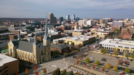 Aerial-Past-A-Cross-On-A-Church-With-The-Skyline-Of-Grand-Rapids,-Michigan-In-The-Background-Suggests-A-Religious-Community