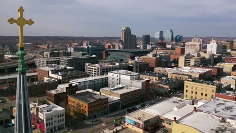 High-Establish-Aerial-Of-A-Cross-On-A-Church-With-The-Skyline-Of-Grand-Rapids,-Michigan-In-The-Background-Suggests-A-Religious-Community