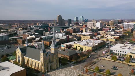 Aerial-Past-A-Cross-On-A-Church-With-The-Skyline-Of-Grand-Rapids,-Michigan-In-The-Background-Suggests-A-Religious-Community