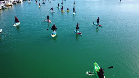 Aerial-Witches-Paddle-On-Surfboards-And-Paddleboards-To-Celebrate-Halloween-In-Ventura-Harbor,-California