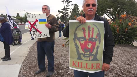 Demonstranten-Versammeln-Sich,-Um-Nach-Der-Russischen-Invasion-Schilder-Zur-Unterstützung-Der-Ukraine-Zu-Halten,-Wobei-Ein-Schild-Putin-Als-Mörder-Identifiziert