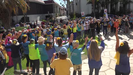 Ukrainians-And-Anti-War-Protesters-Dance-In-A-Circle-And-Pray-Together-During-A-Ukraine-Peace-Rally-In-Santa-Barbara,-California