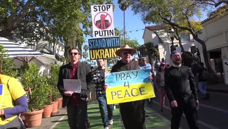 Franciscan-Catholic-Father-Walks-In-Antiwar-Peace-Parade-In-Support-Of-Ukraine-In-Santa-Barbara,-California