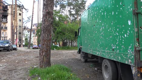 A-Truck-Is-Strafed-With-Bullet-Holes-In-A-Devastated-Neighborhood-In-Irpin,-Ukraine